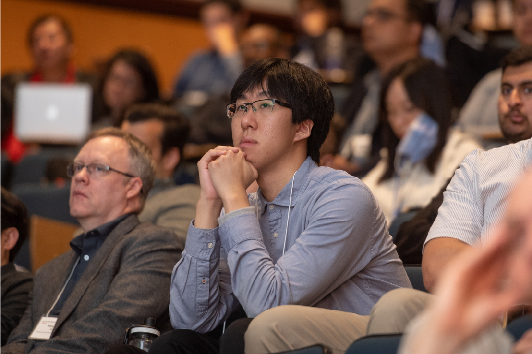 An audience member listens to a speaker at the IGT Symposium.