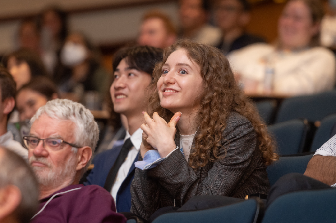 An audience member listens to a speaker at the IGT Symposium.