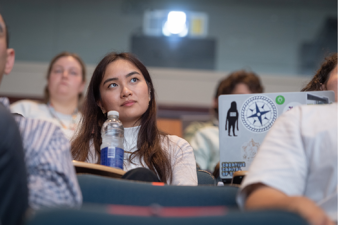 An audience member listens to a speaker at the IGT Symposium.