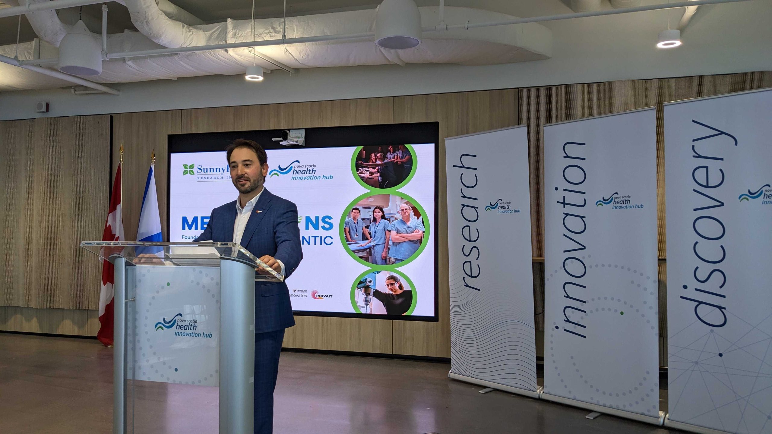 Raphael Ronen gives a speech at a podium at the Medventions Atlantic Launch event in Halifax, Nova Scotia.