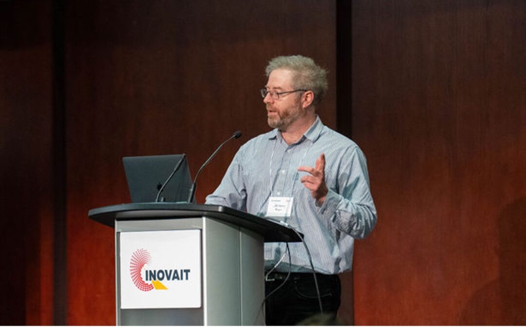 Jeremy Brown, stands at a podium giving a lecture. Jeremy Brown is the Founder of Sound Blade Medical, a 2024 Pilot Fund recipient.