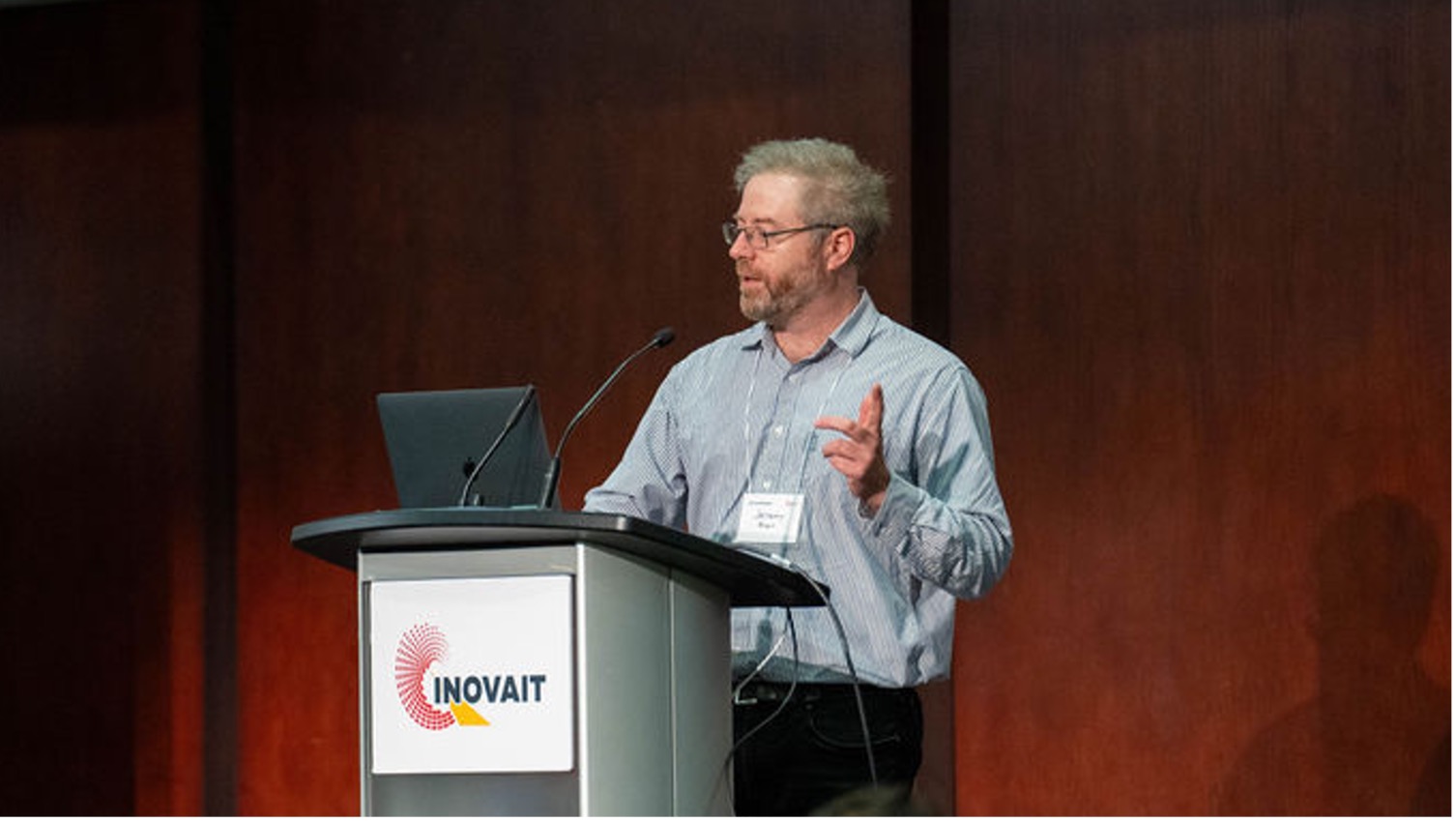 Jeremy Brown, stands at a podium giving a lecture. Jeremy Brown is the Founder of Sound Blade Medical, a 2024 Pilot Fund recipient.